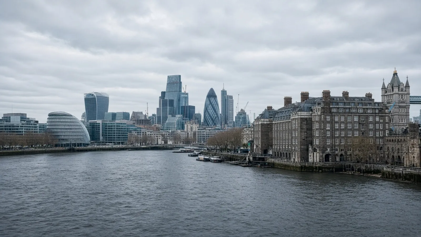 Overcast London riverside cityscape with mixed historic and modern buildings along the Thames